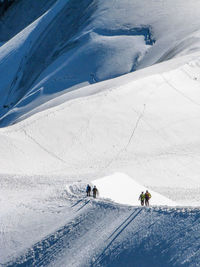 Scenic view of people hiking on mountain