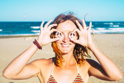 Portrait of woman wearing hat on beach