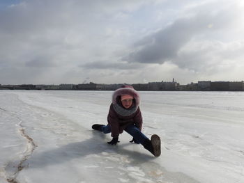 Full length of girl with legs apart on snow