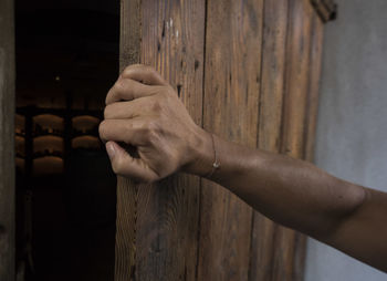 Close-up of man hand on wall