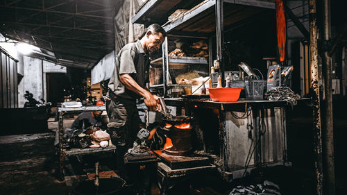 People working on barbecue grill