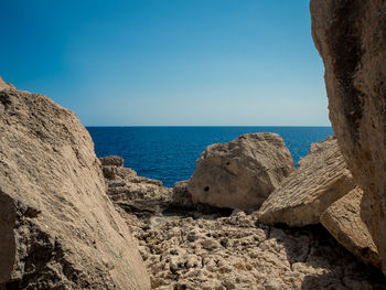 Scenic view of sea against clear blue sky