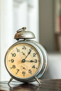 Close-up of clock on table