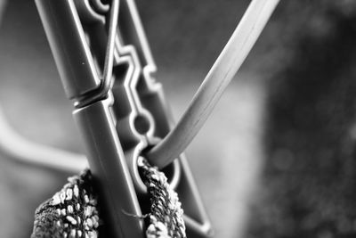 Close-up of bicycle parked by fence