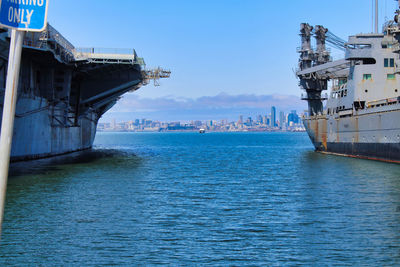 View of city by sea against sky