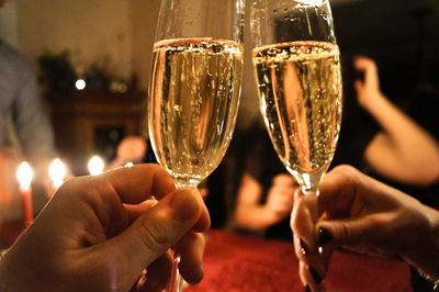Cropped hands of people toasting champagne in party
