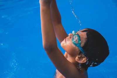 High angle view of boy swimming in pool