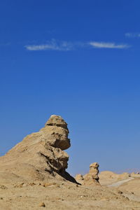 Low angle view of rock formation against sky