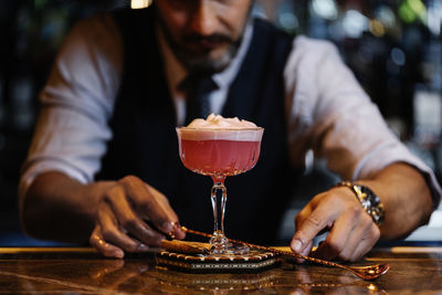 Bartender making drinks at bar