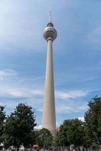 Low angle view of communications tower against sky