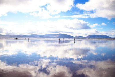 Scenic view of clouds reflecting in water at beach