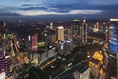 Aerial view of illuminated cityscape against sky at night