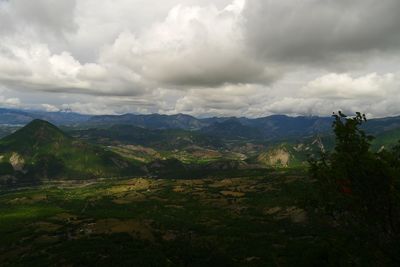 Scenic view of mountains against cloudy sky
