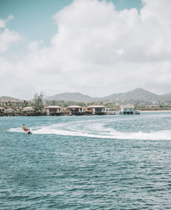 Man wakeboarding in sea against sky