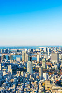 High angle view of buildings against clear blue sky