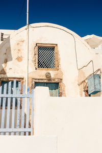 Low angle view of old building against clear blue sky