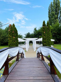 Wooden footbridge against sky