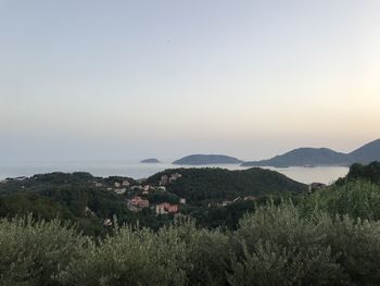 Scenic view of field by mountains against sky