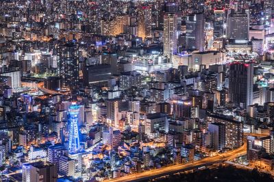 High angle view of city lit up at night