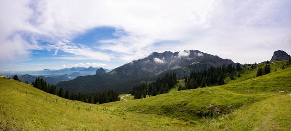 Panoramic view of mountains against cloudy sky