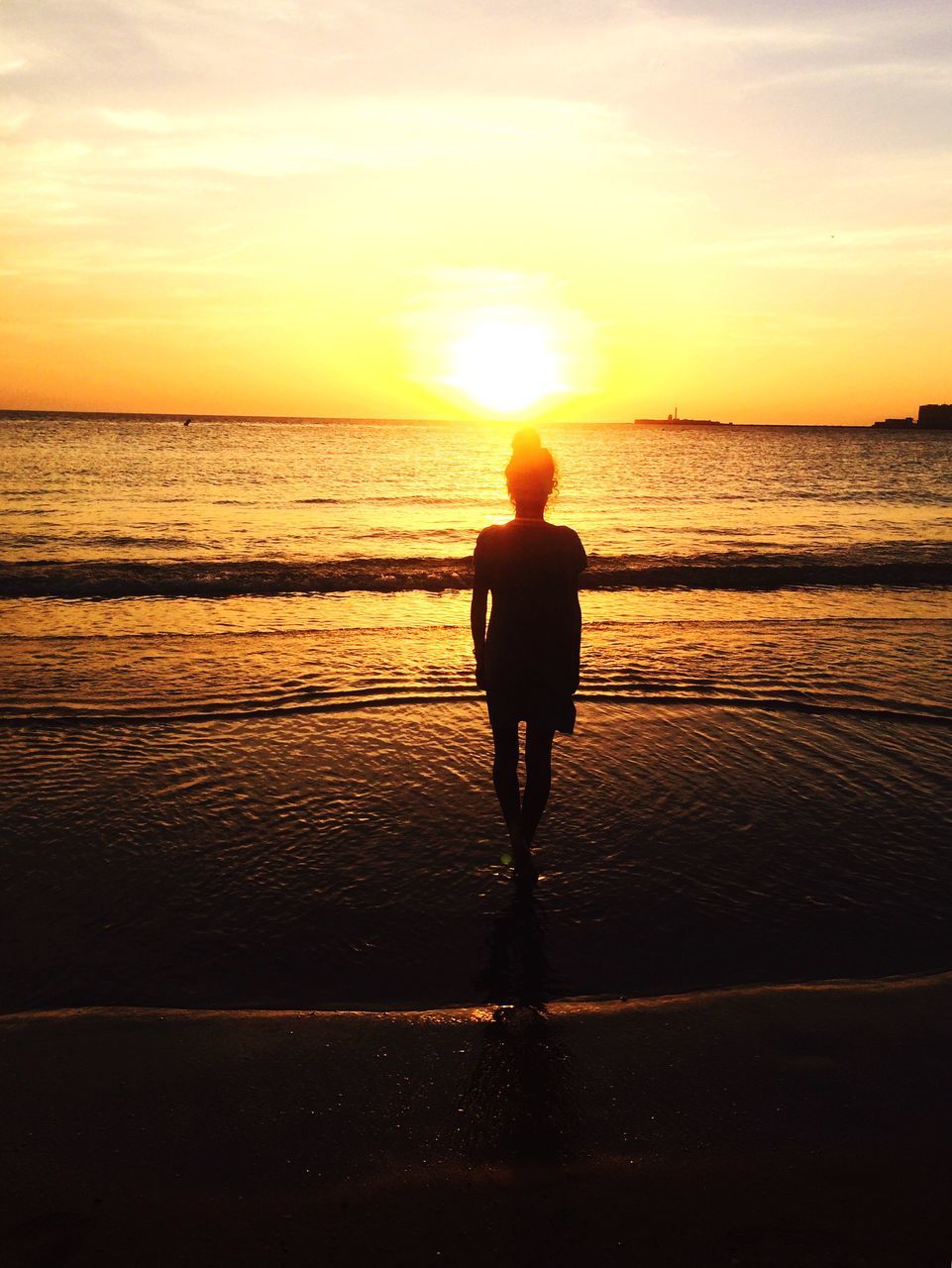 sunset, sea, water, full length, beach, lifestyles, orange color, leisure activity, silhouette, rear view, sky, horizon over water, standing, shore, walking, sun, scenics, person