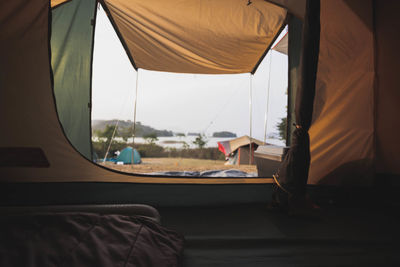 View of tent seen through window