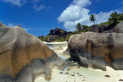 Rocks on beach against sky