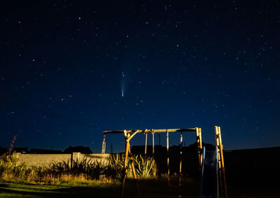 Low angle view of playground against sky at night