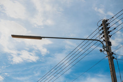 Low angle view of electricity pylon against sky