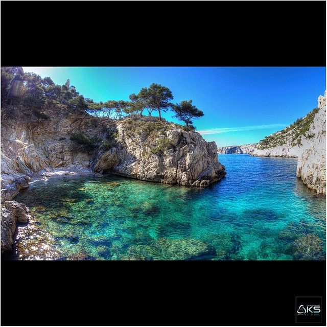 water, sea, transfer print, blue, rock formation, tranquil scene, scenics, rock - object, beauty in nature, tranquility, nature, auto post production filter, rock, clear sky, cliff, idyllic, sky, waterfront, mountain, coastline