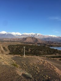 Scenic view of landscape against clear blue sky