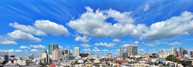 Panoramic view of city buildings against sky