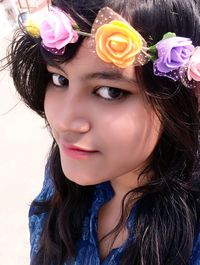 Close-up portrait of beautiful young woman wearing flowers