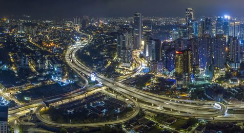 High angle view of illuminated buildings in city at night