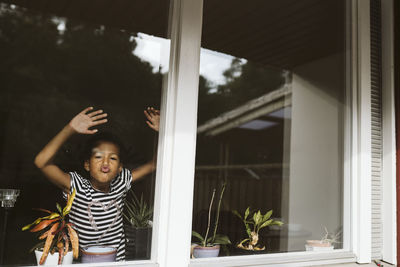 Girl looking through window