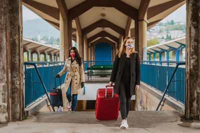 Woman traveling with face mask and bags