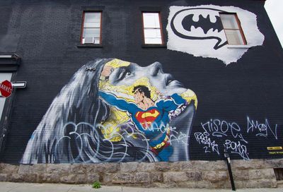Man with graffiti on wall