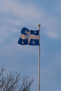 Low angle view of flag against blue sky