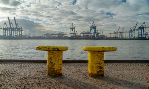 Commercial dock by sea against sky