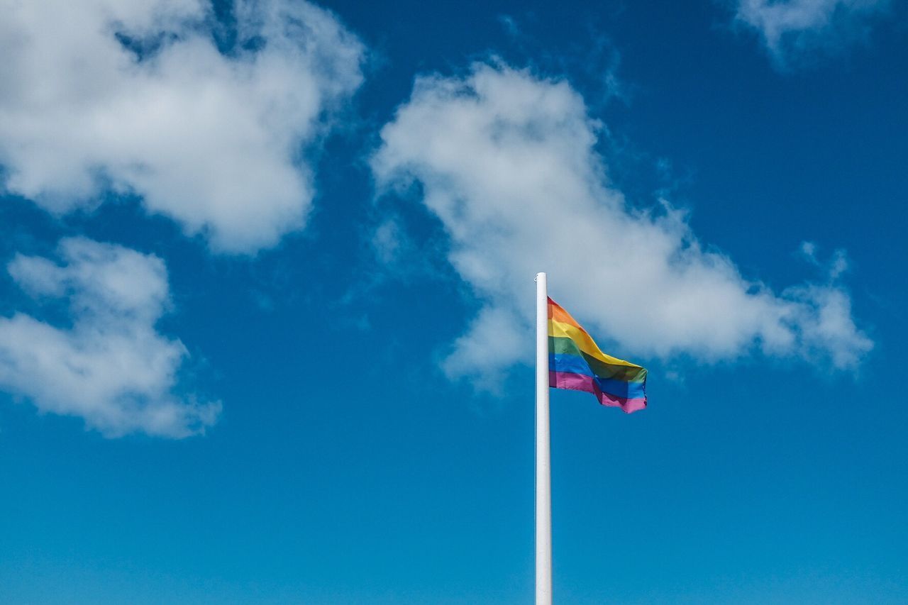 LOW ANGLE VIEW OF FLAGS AGAINST SKY