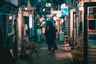 People walking on street in city at night