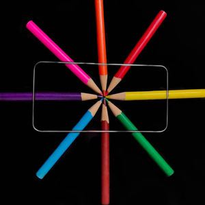 Close-up of multi colored pencils against black background