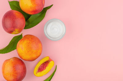 Directly above shot of fruits on pink background