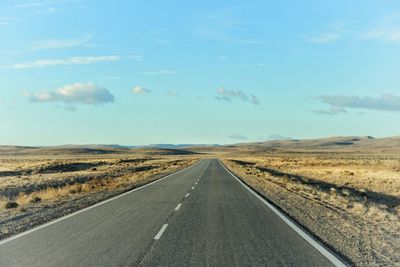 Empty road along countryside landscape