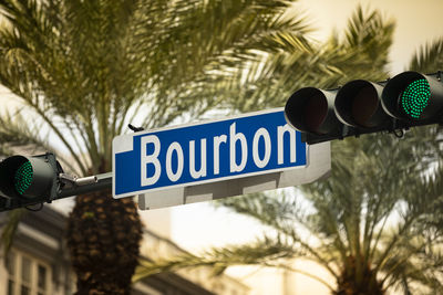 Low angle view of road sign against trees