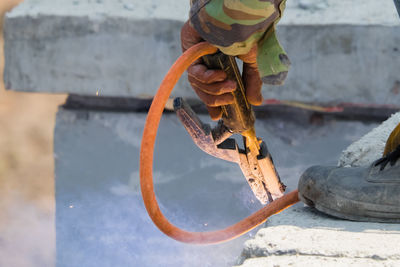 High angle view of rusty metal on rock