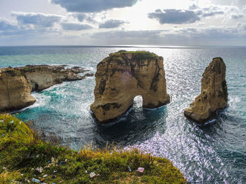 Rock formations by sea against sky