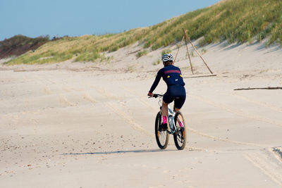 Man riding bicycle on road