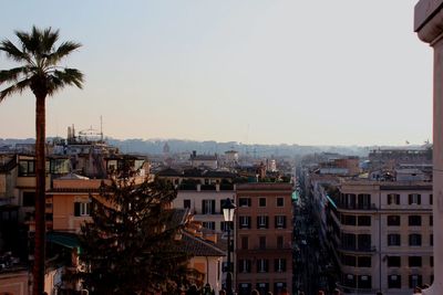 Buildings in city against clear sky