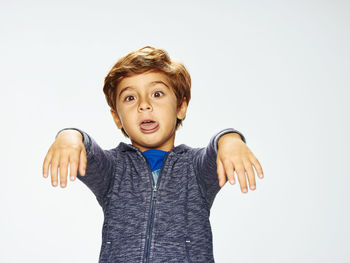 Portrait of boy wearing mask against white background